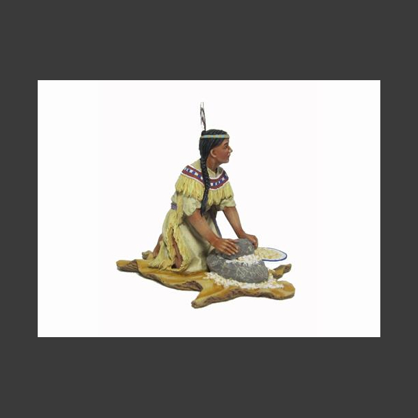 Woman mashing corn w/stone