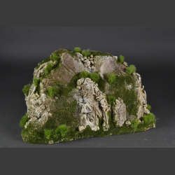 Rocky mountain with green grass peaks