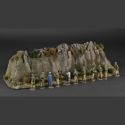 Rocky mountain with withered grass tops and green bushes