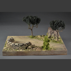 Gravel road through rocks, trees and sandbags cover