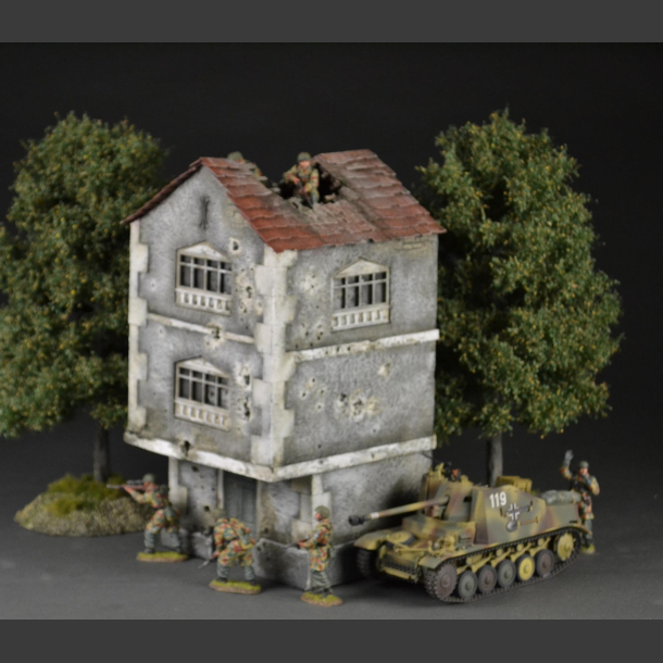 Two-story building with bullet holes and bombed roof