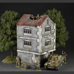 Two-story building with bullet holes and bombed roof