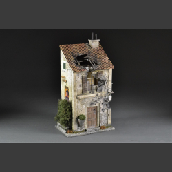 Italian bombed house with balcony and plant pots