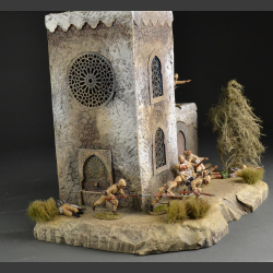 North African Mosque with mosaic fountain on rocky ground