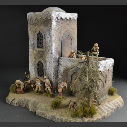 North African Mosque with mosaic fountain on rocky ground