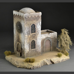 North African Mosque with mosaic fountain on rocky ground