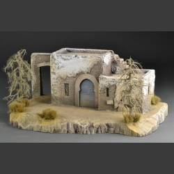 North African house with passage on rocky ground